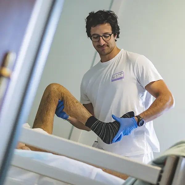 Un fisioterapista della fondazione Gigi Ghirotti presta le cure ad un paziente.